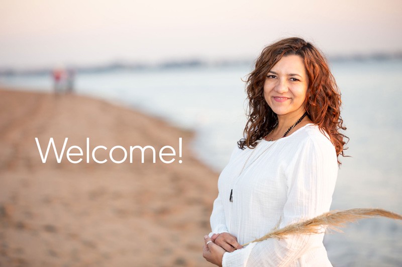 Cheri on the beach with "Starseeds Welcome" message.